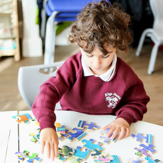 boy completing a puzzle