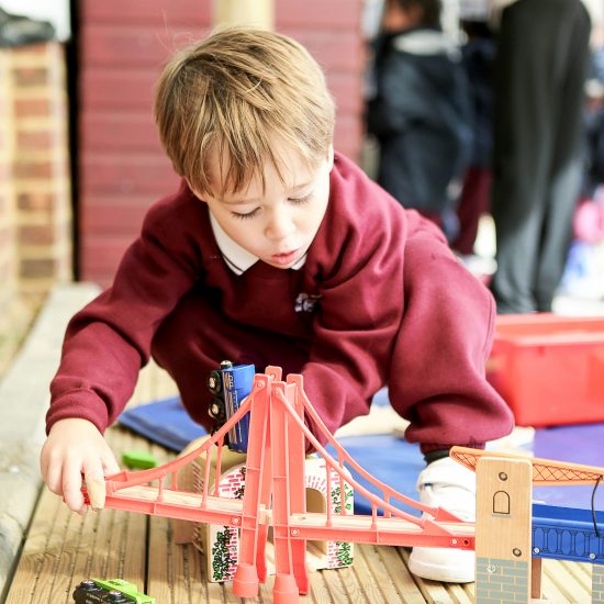 child creating a toy bridge
