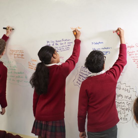 children writing on a board