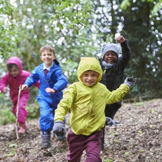 children running through a woods