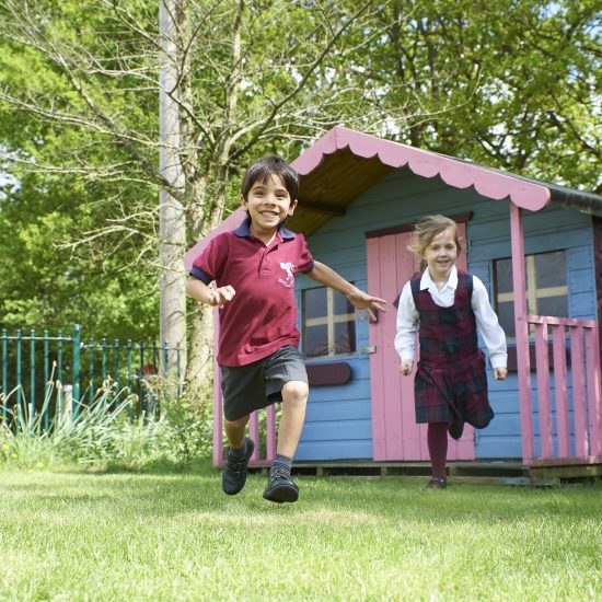 children running from a play house