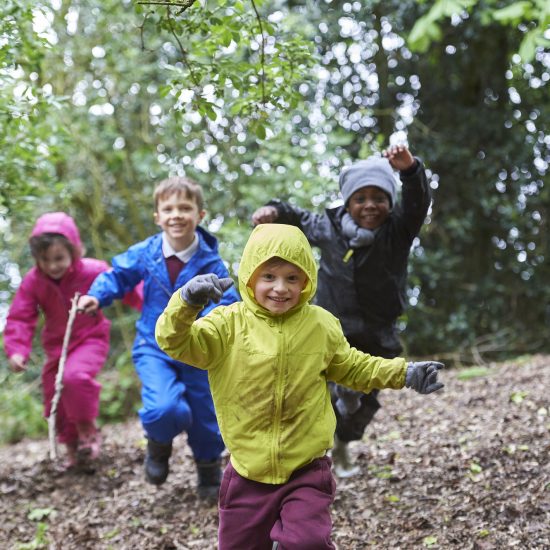 children running in the woods